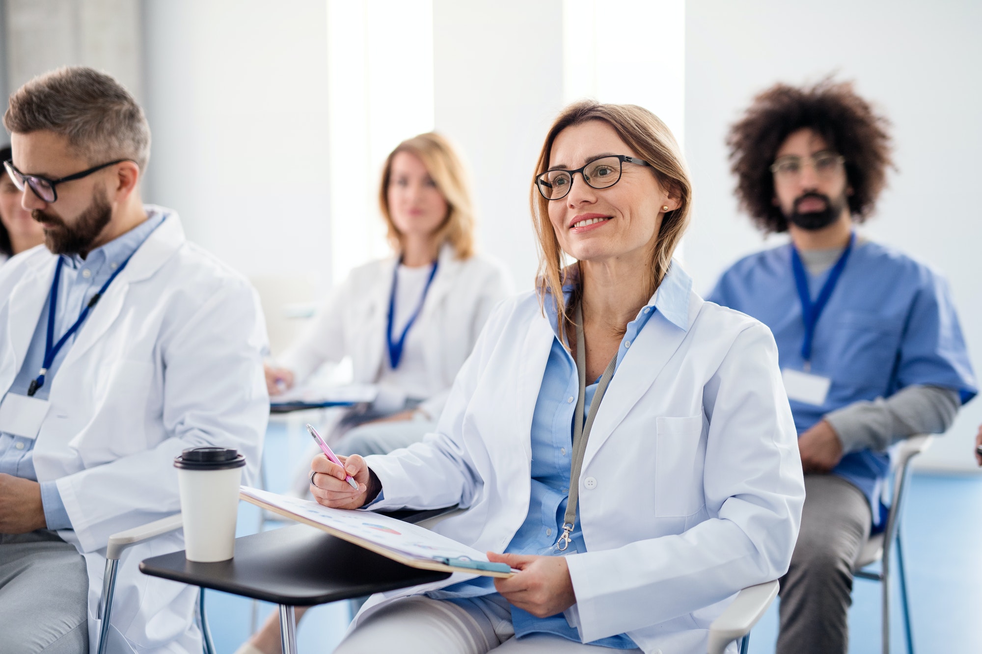 Group of doctors on conference, medical team sitting and listening